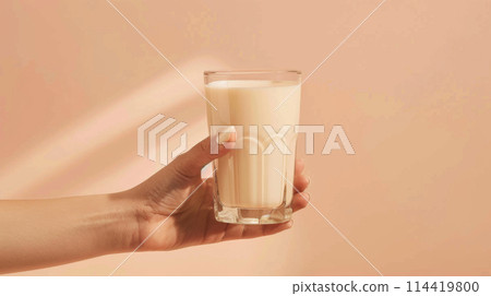She holds a cup of rice milk, a plantbased drink in her hand 114419800