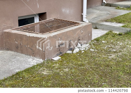 Basement opens in the building of house has window is located below ground level. The window is covered with a lattice of steel rods to protect any entry into the basement Basement opens in the building of house has window is located below ground level. The window is covered with a lattice of steel rods to protect any entry into the basement 114420798