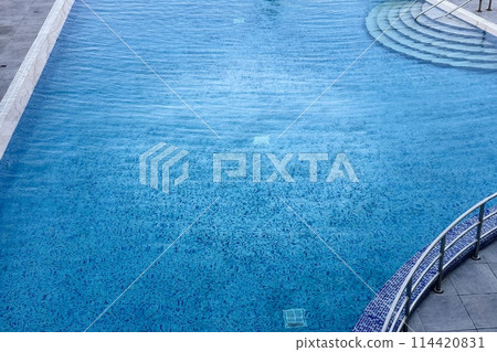 Clean beautiful outdoor pool in a prestigious hotel in a seaside resort. There is sea wave summer texture crystal with waves. Summer vacation concept is on inclusive 114420831