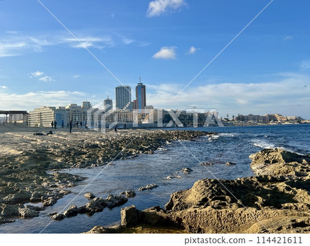 Rocky seashore with blue sea and sky at Sliema, Malta. Natural background 114421611