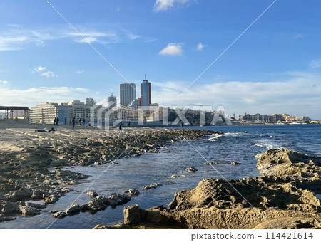 Rocky seashore with blue sea and sky at Sliema, Malta. Natural background 114421614