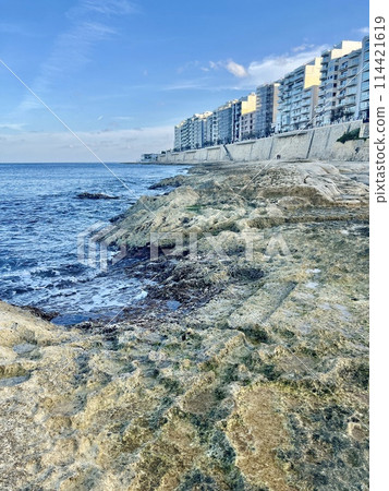Rocky seashore with blue sea and sky at Sliema, Malta. Natural background 114421619