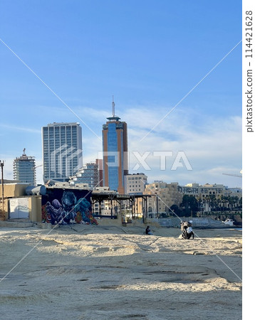 Rocky seashore with blue sea and sky at Sliema, Malta. Natural background Rocky seashore with blue sea and sky at Sliema, Malta. Natural background 114421628