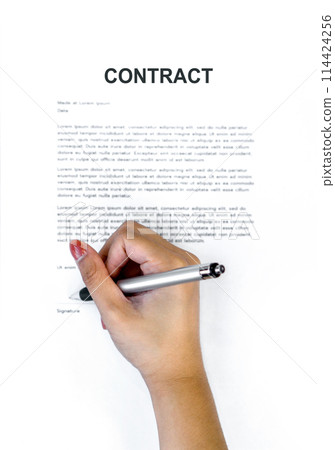 Closeup woman hand holding a pen signing her name on a CONTRACT document. Top View Closeup woman hand holding a pen signing her name on a CONTRACT document. Top View 114424256