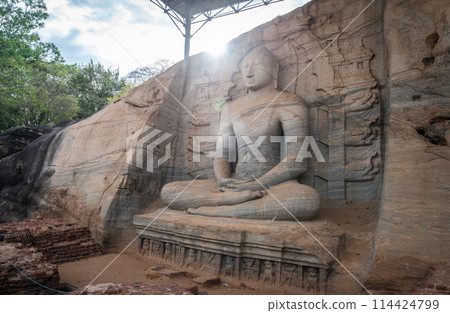 Beautiful sitting Buddha at Gal Vihara. This is an unusual feature in ancient Sinhalese sculpture in ancient city of Polonnaruwa. Gal Vihara is a group of four beautiful Buddhas carved by granite. Beautiful sitting Buddha at Gal Vihara. This is an unusual feature in ancient Sinhalese sculpture in ancient city of Polonnaruwa. Gal Vihara is a group of four beautiful Buddhas carved by granite. 114424799