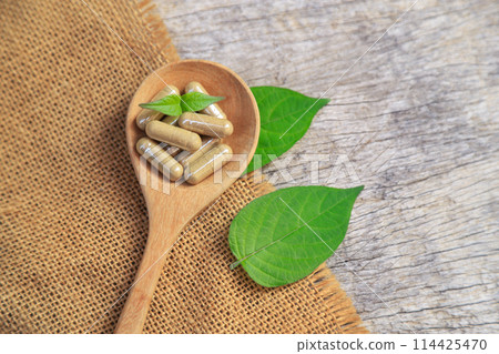 Top view of herbal medicine in capsules from organic herb for health care eating Top view of herbal medicine in capsules from organic herb for health care eating 114425470