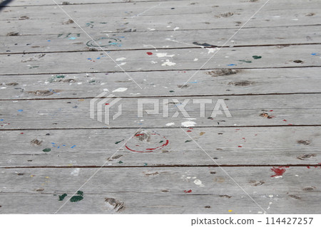 Paint marks on a wooden deck 114427257