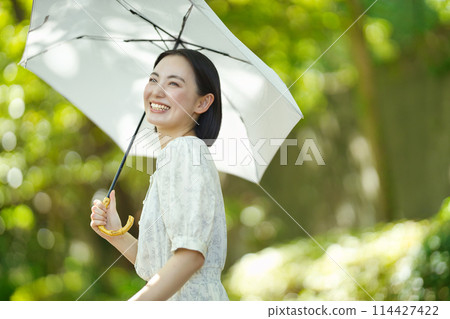拿著遮陽傘的一個少婦 114427422