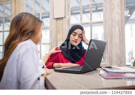 Portrait of a businesswoman getting upset with her colleague during a meeting 114427893