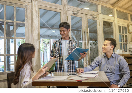 Happy diversity business people smile during a planning, coaching, brainstorming for project meeting in a startup company. Happy diversity business people smile during a planning, coaching, brainstorming for project meeting in a startup company. 114427910