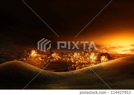 An Image of a city in the desert under attack with explotion and smokes at night. 114427953
