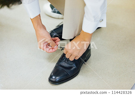 Groom dressing scene Groom dressing scene 114428326