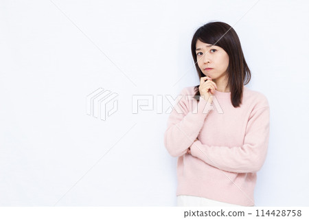 A woman who is seriously worried 114428758