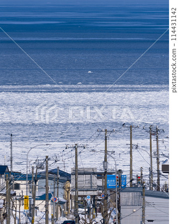 Nemuro, Hokkaido - Nemuro Bay with drift ice ashore and residential areas along the coast / Nemuro, Japan 114431142