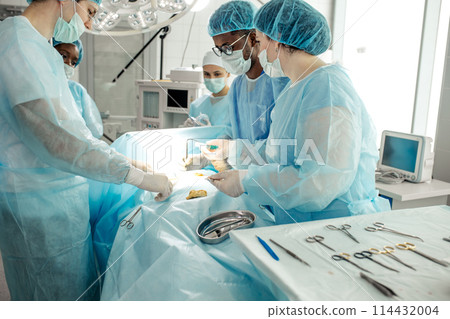 doctors in special uniform smearing antibiotic cream on the wound 114432004