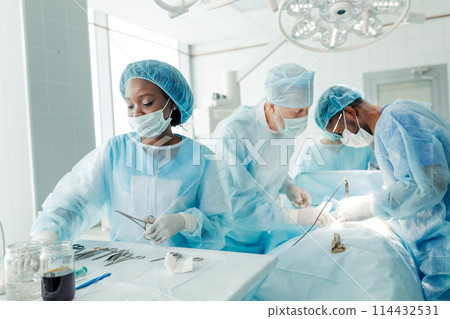 nurse and team of talented doctors using cutting and dissecting instrument 114432531