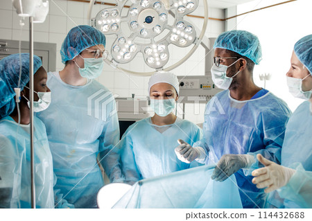 awesome diverse doctors solving problems during operation 114432688