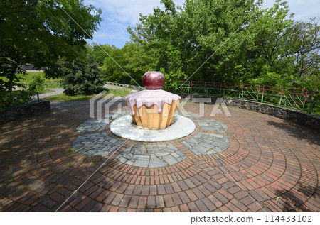 An installation in the form of a cherry cake set for writing wishes in the municipal city park An installation in the form of a cherry cake set for writing wishes in the municipal city park 114433102