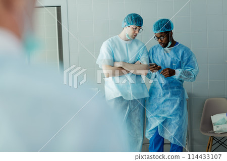serious attractive doctors talking and using smart phone 114433107