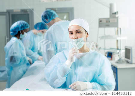 Young tired nurse in cap and face mask Young tired nurse in cap and face mask 114433112