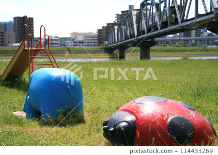 Iron bridge and playground equipment on the riverbed 114433269