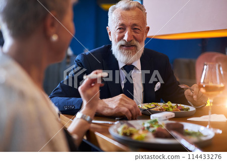 Senior caucasian couple have conversation over fining meal at restaurant 114433276