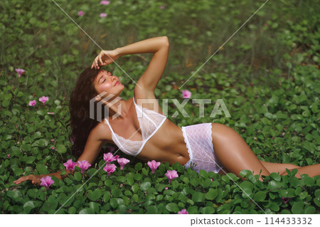 Creative Fashion Photo of Lingerie Model in White Underwear on Flower Meadow Creative Fashion Photo of Lingerie Model in White Underwear on Flower Meadow 114433332