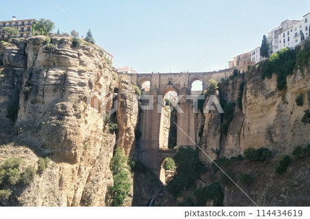 Puente Nuevo arch bridge over the tajo Gorge at Ronda village, Spain. Tourist viewpoint cliff in Ronda province of Malaga, Andalucia Puente Nuevo arch bridge over the tajo Gorge at Ronda village, Spain. Tourist viewpoint cliff in Ronda province of Malaga, Andalucia 114434619