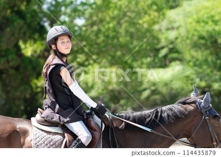 Kids enjoying horseback riding Kids enjoying horseback riding 114435879