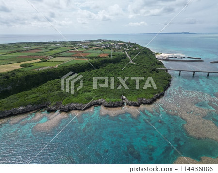 An aerial view of farmland, rocky coastline, and crystal clear sea, where nature and civilization coexist in harmony An aerial view of farmland, rocky coastline, and crystal clear sea, where nature and civilization coexist in harmony 114436086