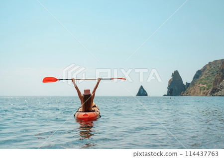 Kayak sea woman. Happy attractive woman with long hair in red swimsuit, swimming on kayak. Summer holiday vacation and travel concept. 114437763