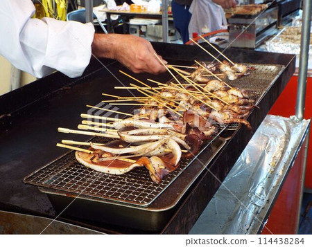 Grilled squid on a skewer at the shrine Grilled squid on a skewer at the shrine 114438284