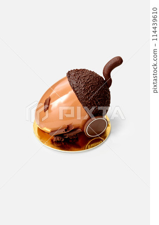 Chocolate acorn shaped cake in glossy ganache on white Chocolate acorn shaped cake in glossy ganache on white 114439610