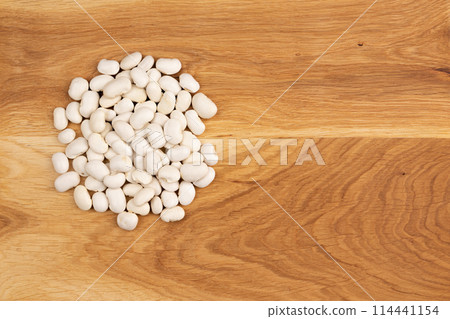 heap of white beans on wooden background, top view heap of white beans on wooden background, top view 114441154