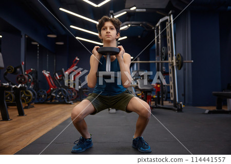 Handsome sporty young boy enjoying fitness activity at gym 114441557