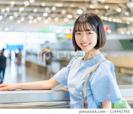 Female traveler waiting to board a flight at the airport_1 114442765