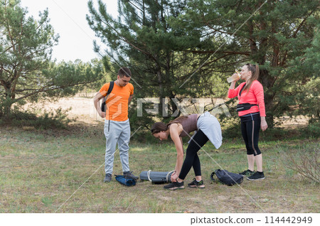 A group of hikers at a rest stop. 114442949