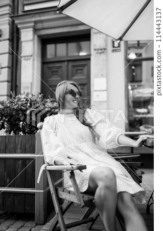 Young Woman chilling in cozy cafe, looking around , happy emotions. Traveling woman. Young Woman chilling in cozy cafe, looking around , happy emotions. Traveling woman. 114443137