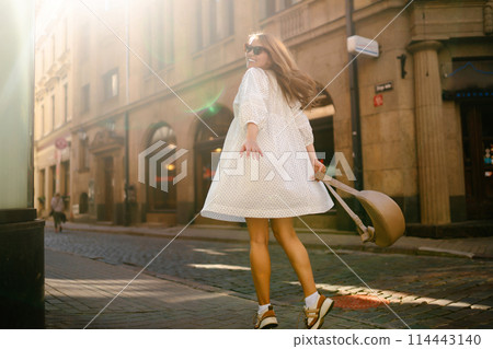 Young beautiful woman walking the streets of an Italian town. Travel and tourism concept. 114443140