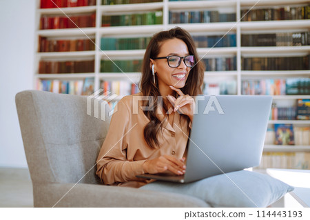 Portrait of happy young woman with laptop. Freelancer working on laptop. Business, online concept. Portrait of happy young woman with laptop. Freelancer working on laptop. Business, online concept. 114443193