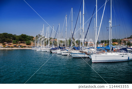 Coastal town and marina with boats and clear blue sky. European travel and vacation concept 114443355