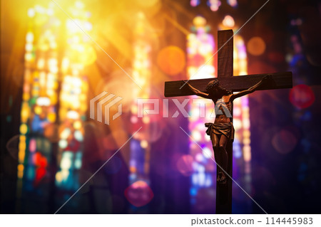 Crucifix with Jesus Christ on cross in church with light coming through stained glass windows - symbol of christian faith religion Crucifix with Jesus Christ on cross in church with light coming through stained glass windows - symbol of christian faith religion 114445983