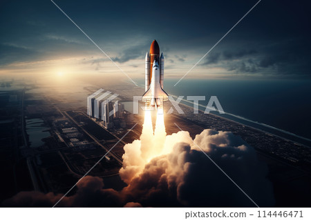 Aerial view of a rocket shuttle carrier launch at sunrise over an ocean coast. The rocket is blasting off with a trail of smoke and flames behind it. 114446471