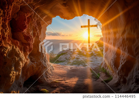 Easter concept cross on Golgotha Calvary hill against a dramatic sunset seen from open tomb of Jesus 114446495