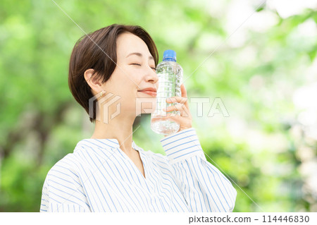 A woman drinking water A woman drinking water 114446830