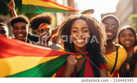 Happy Beautiful African American Woman with red, green and yellow flag symbolizing Juneteenth Freedom and African liberation day. Black life matters. Black history month. 114448345