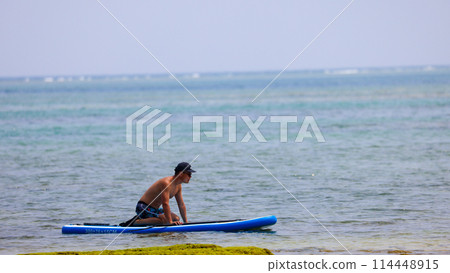 A man enjoying SUP in the beautiful ocean of Okinawa Prefecture A man enjoying SUP in the beautiful ocean of Okinawa Prefecture 114448915