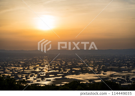 美麗的夕陽映照在充滿水的稻田上|拍攝於富山縣礪波市三鄉村展望廣場 美麗的夕陽映照在充滿水的稻田上|拍攝於富山縣礪波市三鄉村展望廣場 114449035