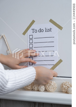 Unrecognizable woman creating vision board with Motivational paper note TO DO LIST. Goals setting concept. Strategy for self development improvement. Inspirational Planning better healthier life 114449988