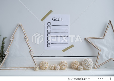 Paper note with inspirational to do checklist GOALS with natural zero waste homemade Christmas decor. Happy new year promises resolutions. Self growth and personal development 114449991